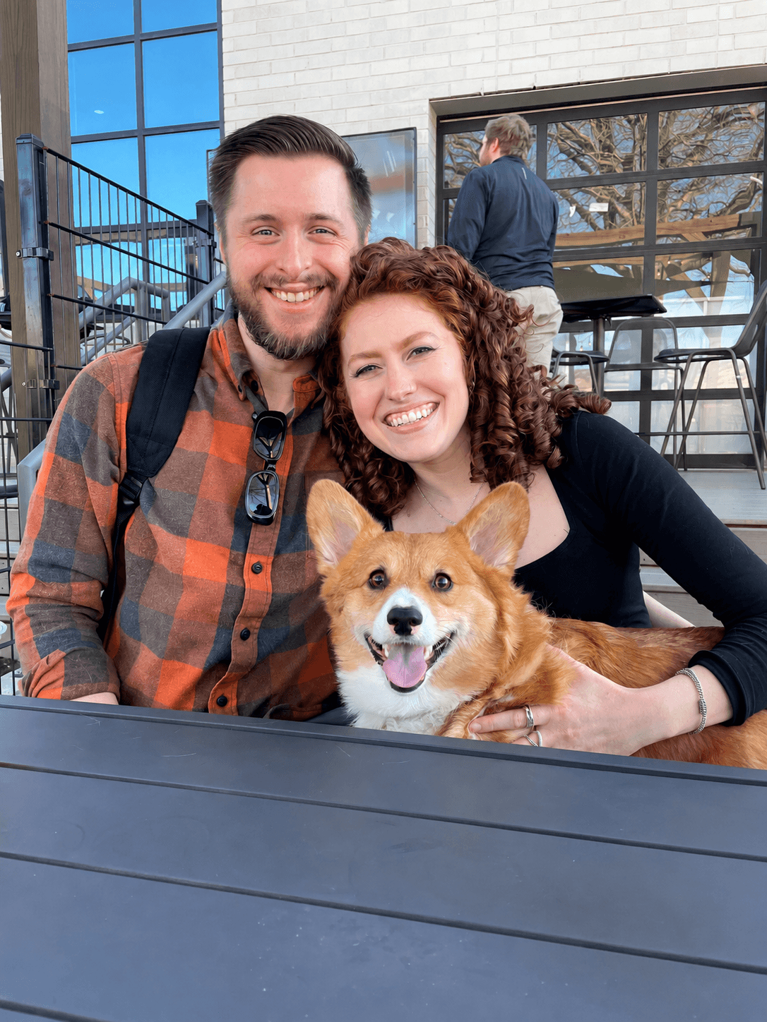 Christian Bobo, Mara, and Sir Waffles smiling together outside
