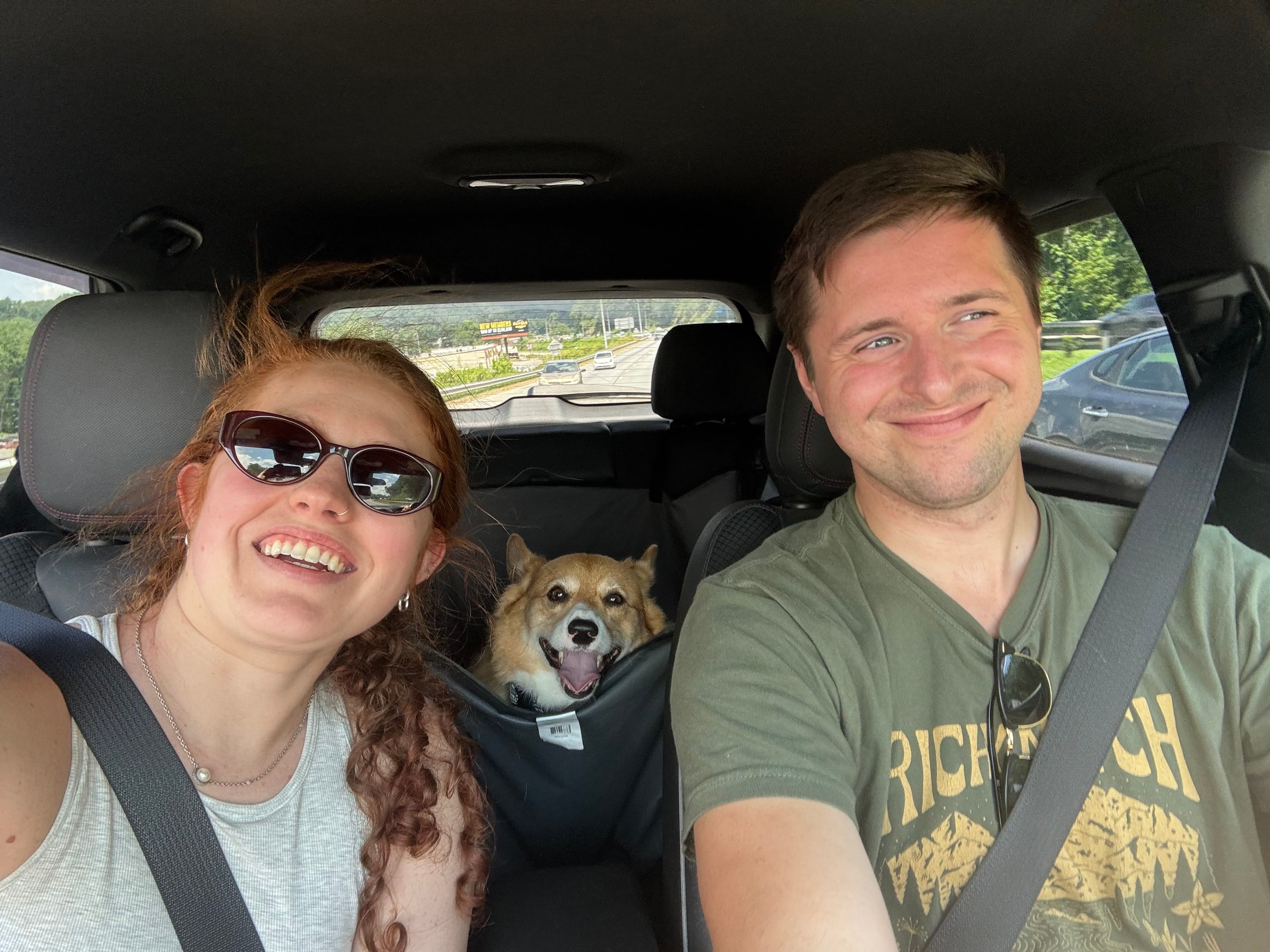 Mara, Christian, and Sir Waffles smiling during a car ride